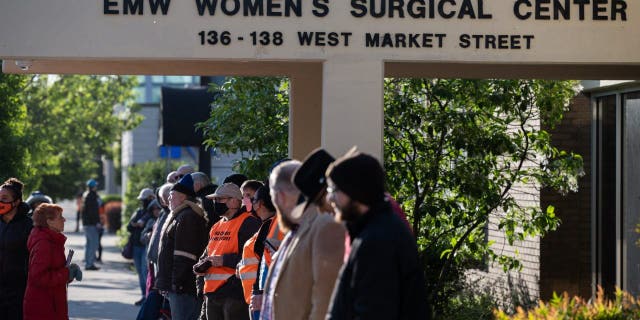 Pro-life demonstrators and clinic escorts stand in front of the EMW Womens Surgical Center, an abortion clinic, on May 8, 2021 in Louisville, Kentucky. 