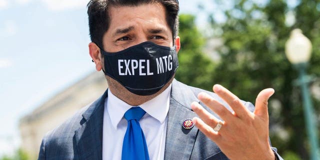 Rep. Jimmy Gomez, D-Calif., wears a mask reading, "EXPEL MTG," referring to Rep. Marjorie Taylor Greene, R-Ga., outside the Capitol on May 13, 2021.