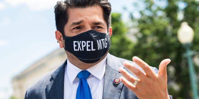 Rep. Jimmy Gomez, D-Calif., wears a mask reading, "EXPEL MTG," referring to Rep. Marjorie Taylor Greene, R-Ga., outside the Capitol on May 13, 2021.