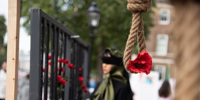 An installation of hanging noose and red flower at Whitehall in London Aug. 28, 2021, drawing attention to the 1988 Massacre of the Political Prisoners in Iran.