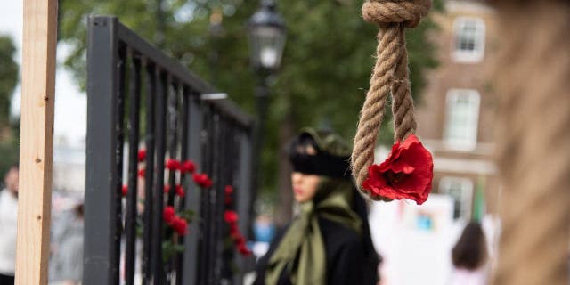 An installation of hanging noose and red flower at Whitehall in London Aug. 28, 2021, drawing attention to the 1988 Massacre of the Political Prisoners in Iran.