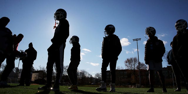Players line up during the Dorchester Eagles Pop Warner football team practice on November 27, 2021 in the Dorchester neighborhood of Boston, MA.  Coaches Tony Hurston and Terry Cousins ​​led the Eagles to a spot in Pop Warner's annual Super Bowl championship. 