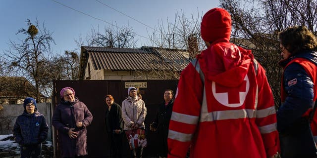 Red Cross workers arrive to deliver aid to residents in Eastern Kharkiv, Ukraine, March 23, 2022. 