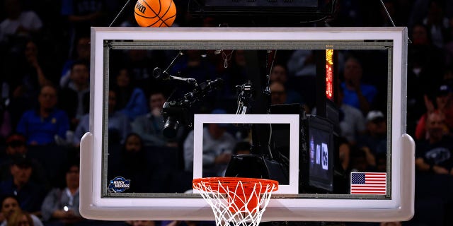 The game ball gets stuck on the backboard in the NCAA Men's Basketball Tournament in 2022.