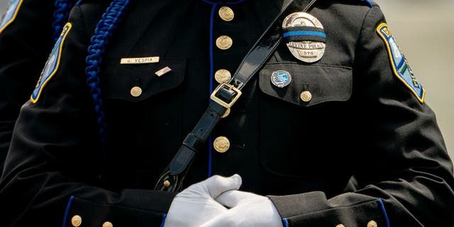 A law enforcement officer crosses their hands during the National Peace Officers Memorial Service at the US Capitol in Washington, DC, on May 15, 2022. 