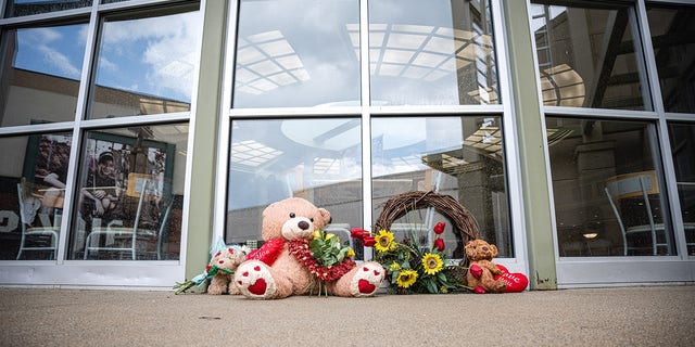 Teddy bears and flowers are sit as a memorial outside of theGreenwood Park Mall food court on July 18, 2022 in Greenwood, Indiana. 
