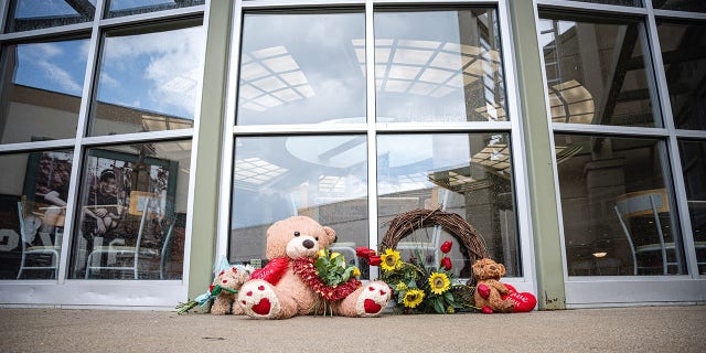 Teddy bears and flowers are sit as a memorial outside of theGreenwood Park Mall food court on July 18, 2022 in Greenwood, Indiana. 