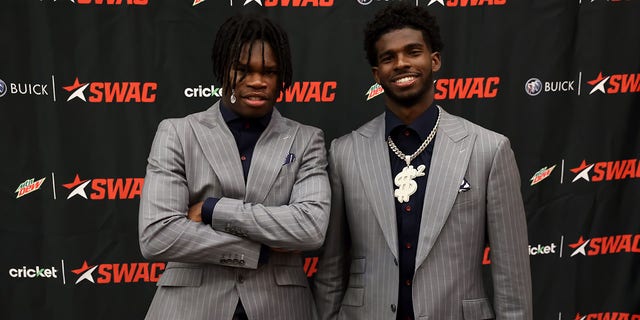 Jackson State Tigers wide receiver Travis Hunter and Jackson State Tigers quarterback Shedeur Sanders pose for media photos during the 2022 SWAC Football Media Day on July 21, 2022 at the Birmingham Sheraton Hotel in Birmingham, Alabama.  