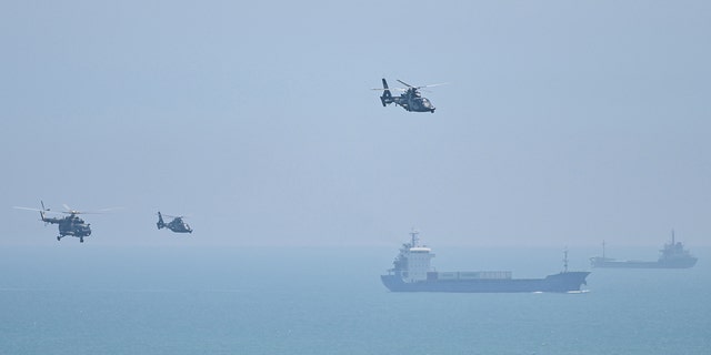 Chinese military helicopters fly past Pingtan island, one of mainland China's closest point from Taiwan, in Fujian province on August 4, 2022.