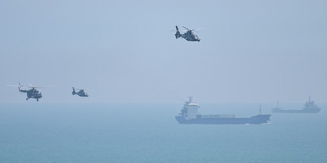 Chinese military helicopters fly past Pingtan island, one of mainland China's closest point from Taiwan, in Fujian province on August 4, 2022.