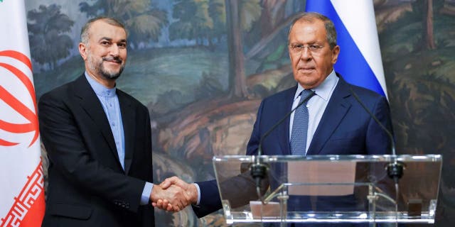 Russian Foreign Minister Sergei Lavrov, right, and Iranian Foreign Minister Hossein Amir-Abdollahian shake hands during a joint news conference as part of their meeting in Moscow on Aug. 31, 2022.