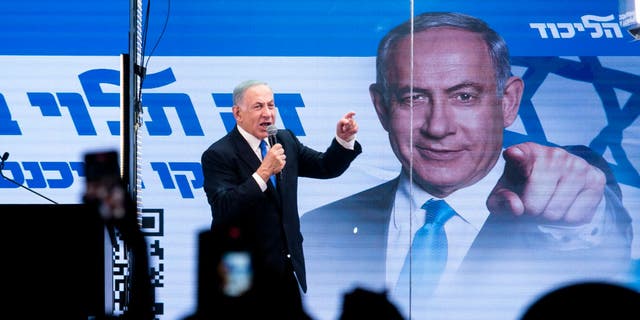 Former Israeli Prime Minister and Likud Party leader Benjamin Netanyahu speaks to supporters inside a modified truck with bulletproof glass during a campaign event Oct. 29, 2022, in Bnei Brak, Israel. 