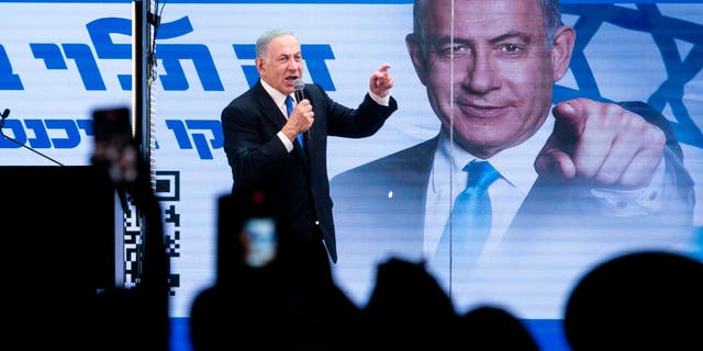 Former Israeli Prime Minister and Likud Party leader Benjamin Netanyahu speaks to supporters inside a modified truck with bulletproof glass during a campaign event Oct. 29, 2022, in Bnei Brak, Israel.