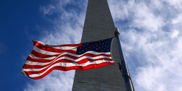 U.S. flag and the Washington Monument at the National Mall in Washington, D.C., United States, on Oct. 20, 2022. 