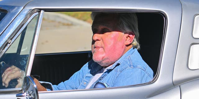 Jay Leno's burns are visible on his face as he drives around in Los Angeles, weeks after his accident.