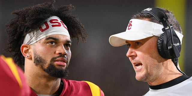 USC quarterback Caleb Williams, left, talks with head coach Lincoln Riley during the game against Notre Dame, Nov. 26, 2022, at Los Angeles Memorial Coliseum in Los Angeles.