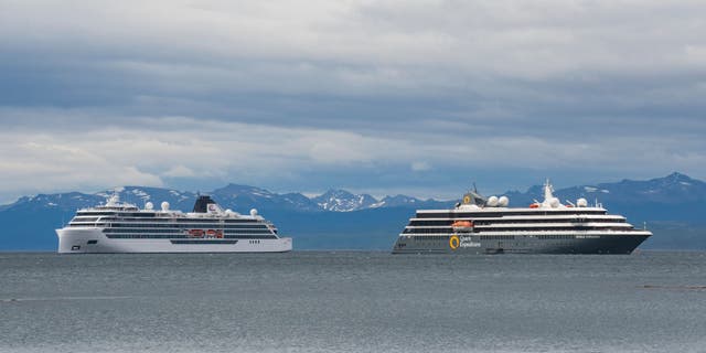 The Norwegian-flagged cruise ship Viking Polaris, left, and MV World Explorer ship, chartered by Quark Expeditions, are seen anchored in waters of the Atlantic Ocean in Ushuaia, southern Argentina, on Dec. 1, 2022.