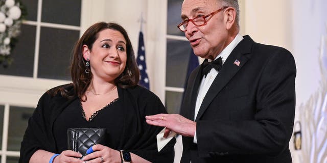 Senate Majority Leader Chuck Schumer and his daughter Jessica Emily Schumer arrive at the White House to attend a state dinner honoring French President Emmanuel Macron, on Dec. 1, 2022.