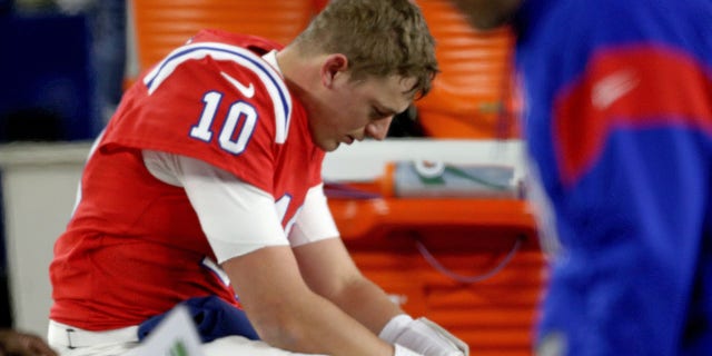 Mac Jones of the New England Patriots sits on the bench after losing 24-10 against the Buffalo Bills at Gillette Stadium Dec. 1, 2022, in Foxboro, Mass. 