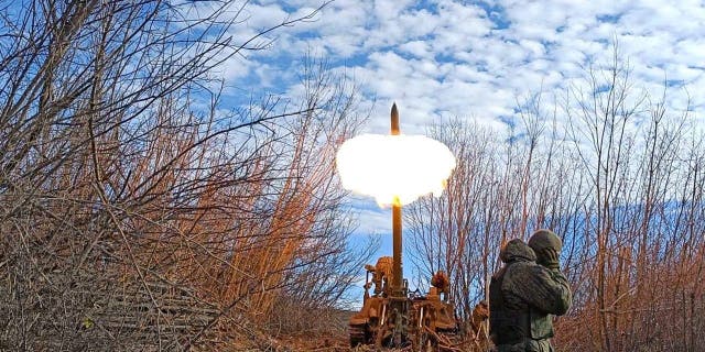 Armed members of the self-proclaimed Donetsk People's Republic (DPR) fire howitzer on Bakhmut border front in Donetsk, Ukraine on Dec. 1, 2022. 