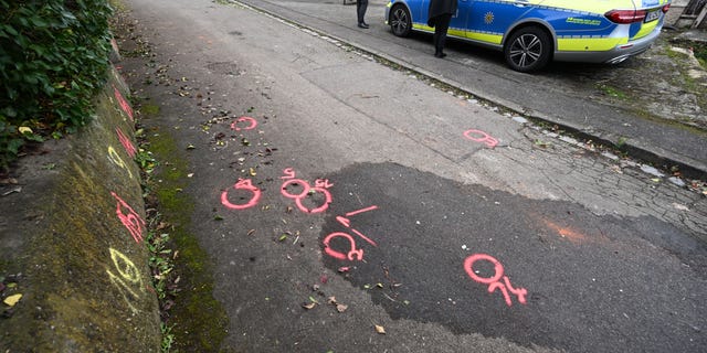 Police forensics markers are placed at a crime scene on a path where two girls were attacked on their way to school in Illerkirchberg, Germany. 