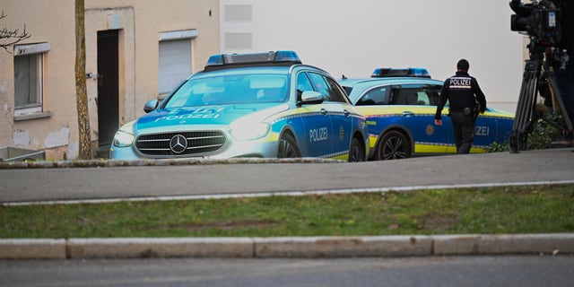 Police vehicles parked at a crime scene in Illerkirchberg, Germany. 
