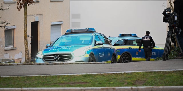 Police vehicles parked at a crime scene in Illerkirchberg, Germany. 