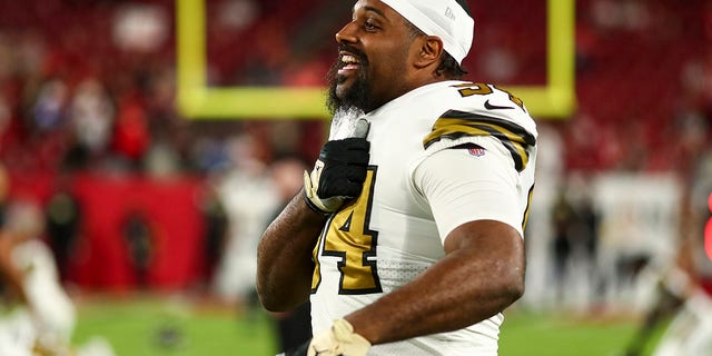 Cameron Jordan of the New Orleans Saints yells to teammates while stretching prior to a game against the Tampa Bay Buccaneers at Raymond James Stadium Dec. 5, 2022, in Tampa, Fla. 