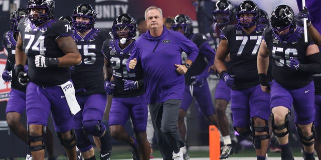 TCU head coach Sonny Dykes leads his team onto the field for the Big 12 Championship Game between the TCU Horned Frogs and the Kansas State Wildcats on December 03, 2022, at AT&T Stadium in Arlington, Texas.