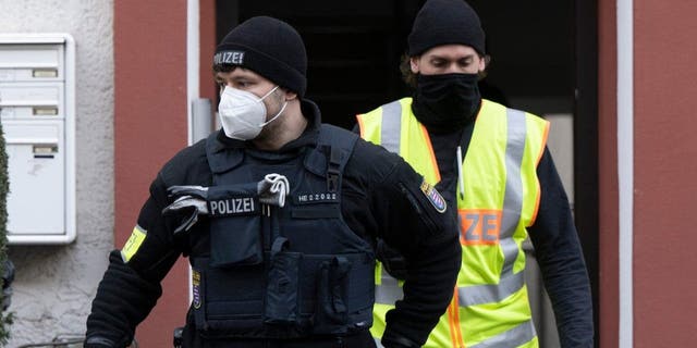 Police officers secure a searched property in Frankfurt, Germany, Dec. 7, 2022, during a raid against so-called "Reich citizens."