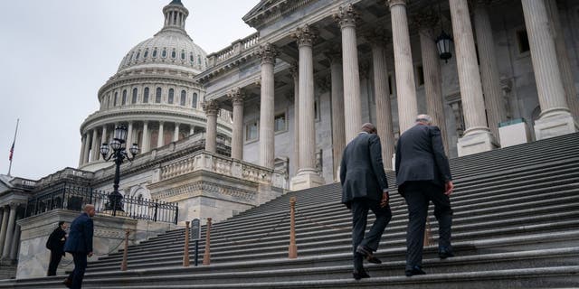 Lawmakers walk on the east front of the U.S. Capitol Building on Wednesday, Dec. 7, 2022, in Washington, DC.