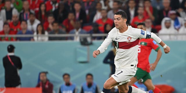 Portugal's forward #7 Cristiano Ronaldo controls the ball during the Qatar 2022 World Cup quarter-final football match between Morocco and Portugal at the Al-Thumama Stadium in Doha on December 10, 2022. 