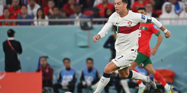 Portugal's forward #07 Cristiano Ronaldo controls the ball during the Qatar 2022 World Cup quarter-final football match between Morocco and Portugal at the Al-Thumama Stadium in Doha on December 10, 2022.