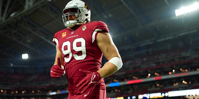 JJ Watt of the Arizona Cardinals warms up before kickoff against the New England Patriots at State Farm Stadium on December 12, 2022 in Glendale, Arizona.