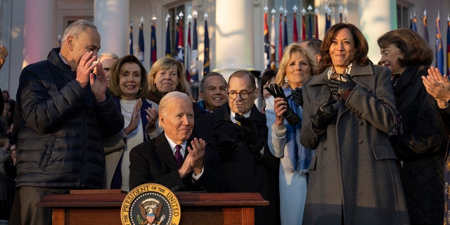 US President Joe Biden applauds after signing the Respect Marriages Act on the South Lawn of the White House on December 13, 2022 in Washington, DC.