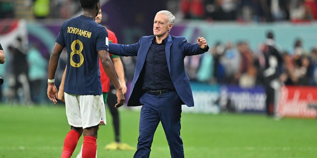 Aurelien Tchouameni (8) of France celebrates with head coach Didier Deschamps (R) after winning the FIFA World Cup Qatar 2022 semi final match between France and Morocco at Al Bayt Stadium on December 14, 2022 in Al Khor, Qatar.