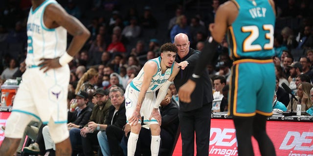 Head coach Steve Clifford of the Hornets talks to LaMelo Ball during the game against the Detroit Pistons on Dec. 14, 2022, at Spectrum Center in Charlotte, North Carolina.