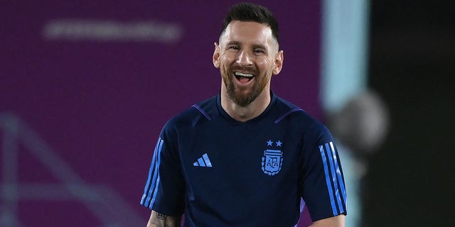 Argentina's forward #10 Lionel Messi laughs during a training session at Qatar University training site 3 in Doha on December 17, 2022, on the eve of the Qatar 2022 World Cup football final match between Argentina and France. 