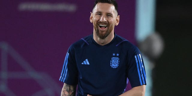 Argentina's forward #10 Lionel Messi laughs during a training session at Qatar University training site 3 in Doha on December 17, 2022, on the eve of the Qatar 2022 World Cup football final match between Argentina and France. 