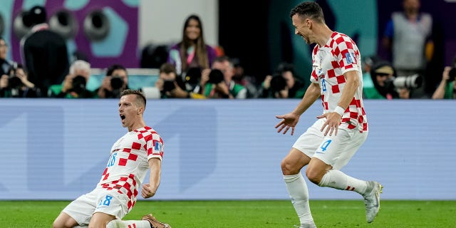 Mislav Orsic of Croatia celebrates after scoring his team's second goal with Ivan Perisic of Croatia during the FIFA World Cup Qatar 2022 3rd Place match between Croatia and Morocco at Khalifa International Stadium on December 17, 2022 in Doha, Qatar.