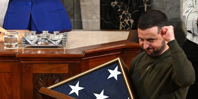 President Volodymyr Zelenskyy receives from House Speaker Nancy Pelosi a U.S. flag during his address to Congress at the Capitol on Dec. 21, 2022.