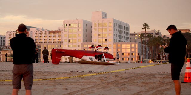 An investigation is underway into the crash of a single-engine Cessna plane after the pilot landed on the beach south of the pier, Thursday, Dec. 22, 2022, in Santa Monica, California.  Firefighters were called to the 1800 block of Santa Monica Beach at 3:17 p.m., said Capt. Patrick Nulty, a spokesman for the city's fire department.  Both occupants were rescued and taken to hospital.