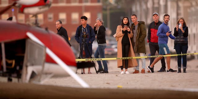 An investigation in underwater as a single-engine Cessna airplane flipped over after the pilot landed on the beach south of the pier on Thursday, Dec. 22, 2022 in Santa Monica, California. Firefighters were called at 3:17 pm to the 1800 block of Santa Monica Beach, said Capt. Patrick Nulty, a spokesperson for the city's fire department. Both occupants were rescued and transported to a hospital.