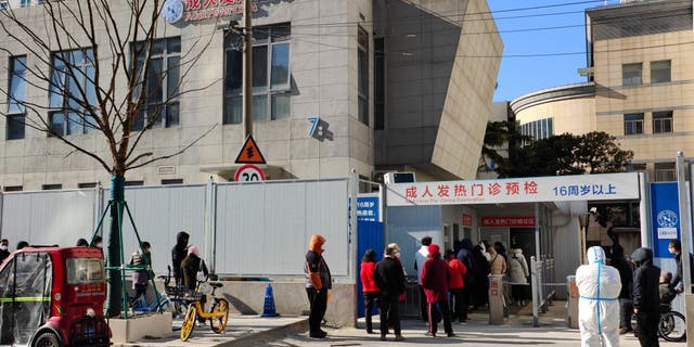 SHANGHAI, CHINA - DECEMBER 24, 2022 - Patients line up outside a fever clinic at a hospital in Shanghai, China, December 24, 2022. 