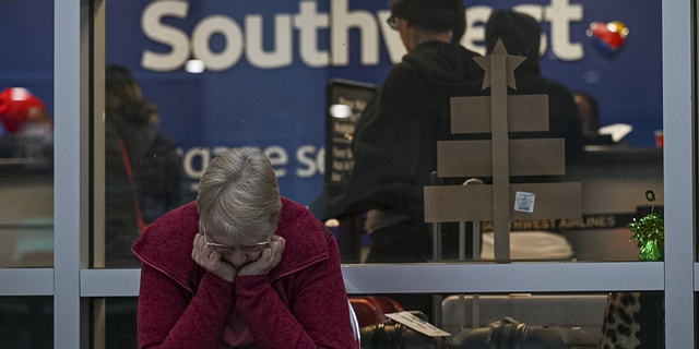 A traveler waits outside the Southwest Airlines baggage office at Oakland International Airport in Oakland, California on Wednesday.