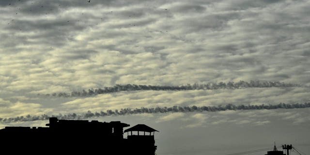 TOPSHOT - Missiles contrails are seen in the sky over Kyiv on December 29, 2022 amid the Russian invasion of Ukraine.