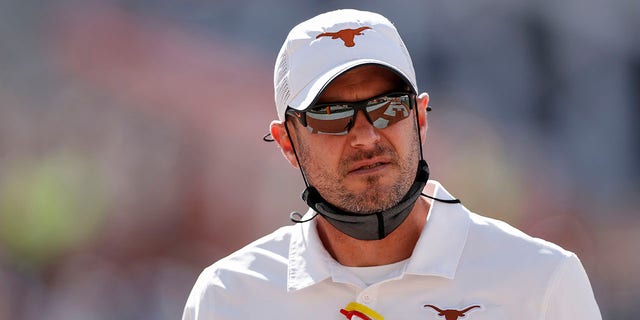 Texas Longhorns head coach Tom Herman watches players warm up before the game against the West Virginia Mountaineers at Darrell K Royal-Texas Memorial Stadium on Nov. 7, 2020 in Austin, Texas. 