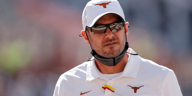 Texas Longhorns head coach Tom Herman watches players warm up before the game against the West Virginia Mountaineers at Darrell K Royal-Texas Memorial Stadium on Nov. 7, 2020 in Austin, Texas.