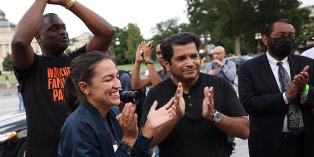 From left: Reps. Mondaire Jones, D-N.Y.; Alexandria Ocasio-Cortez, D-N.Y.; Jimmy Gomez, D-Calif.; and Al Green, D-Texas, applaud during a rally on the eviction moratorium at the U.S. Capitol  in Washington, D.C., on Aug. 3, 2021.