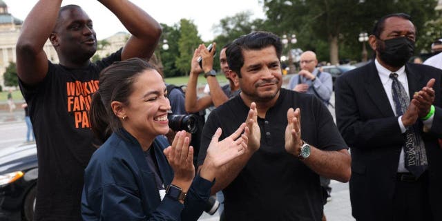 From left: Reps. Mondaire Jones, D-N.Y.; Alexandria Ocasio-Cortez, D-N.Y.; Jimmy Gomez, D-Calif.; and Al Green, D-Texas, applaud during a rally on the eviction moratorium at the U.S. Capitol in Washington, D.C., on Aug. 3, 2021.